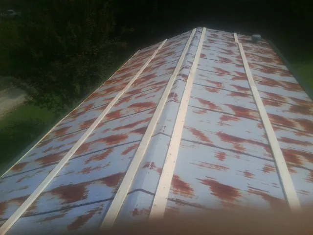 Rusted metal roof panels with new wood purlins before replacement — Storm Damage Roof Repair in Cassandra by Roofing Brothers