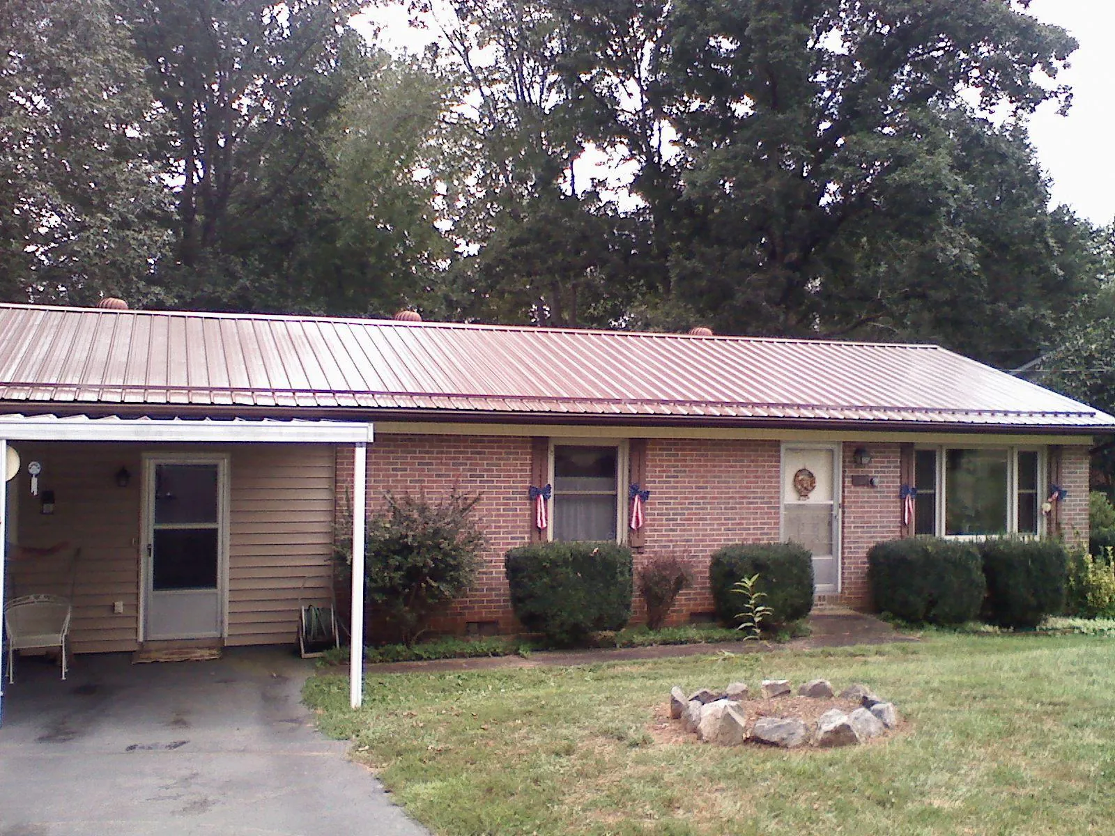 Bronze metal roof and carport on a brick ranch home — Roof Repair work by our crew in Cassandra